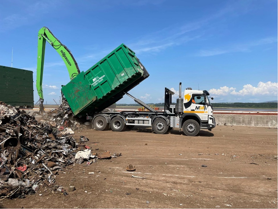 dumping scrap metal on a heap