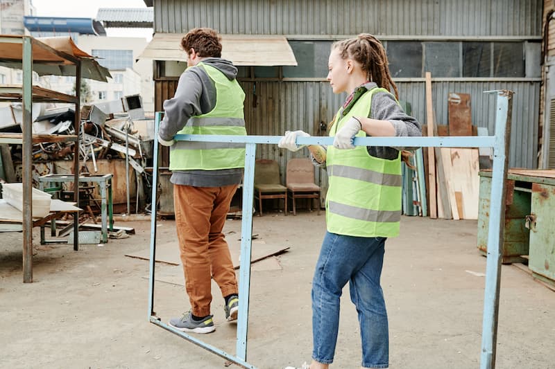 workers in high vis moving metal frame